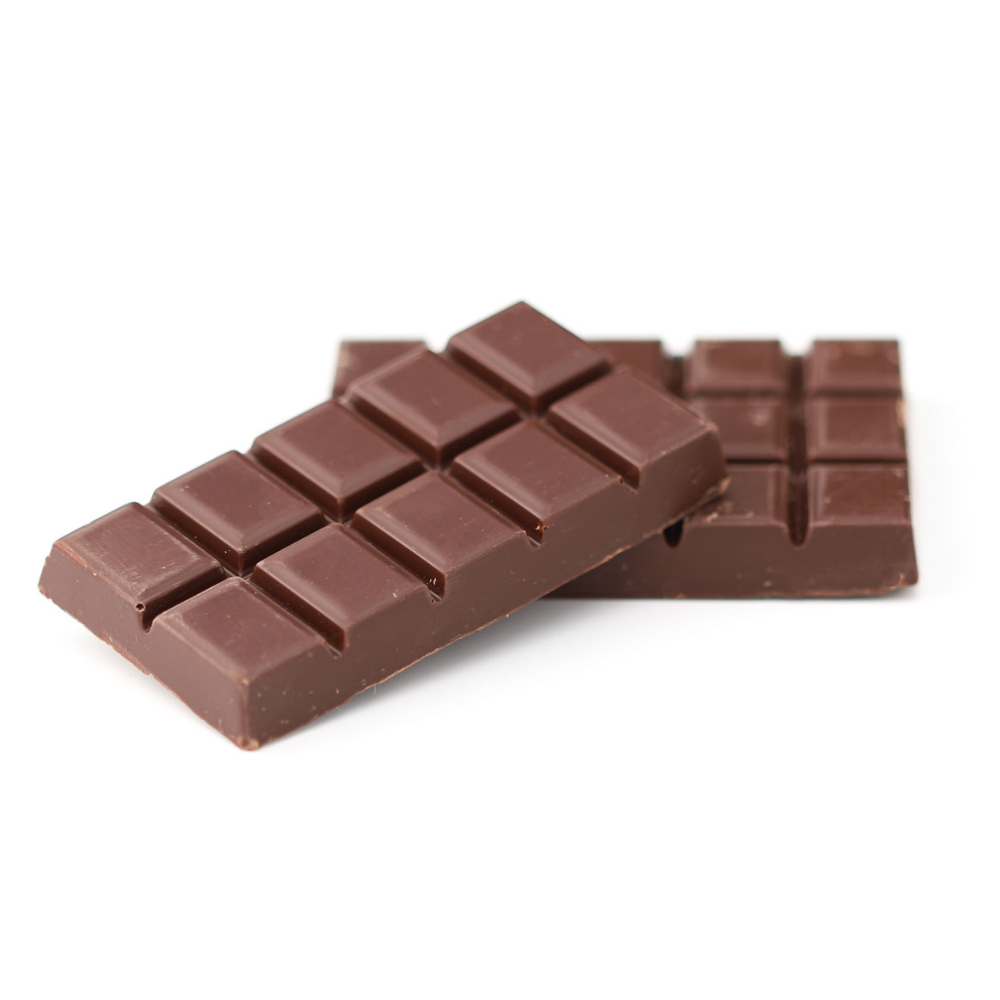 Milk chocolate bars stacked on a white background, showing smooth rectangular segments and a glossy finish.