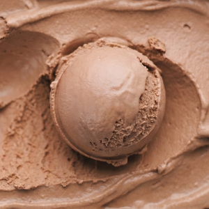 Close-up scoop of chocolate only ice cream with a smooth, creamy texture.