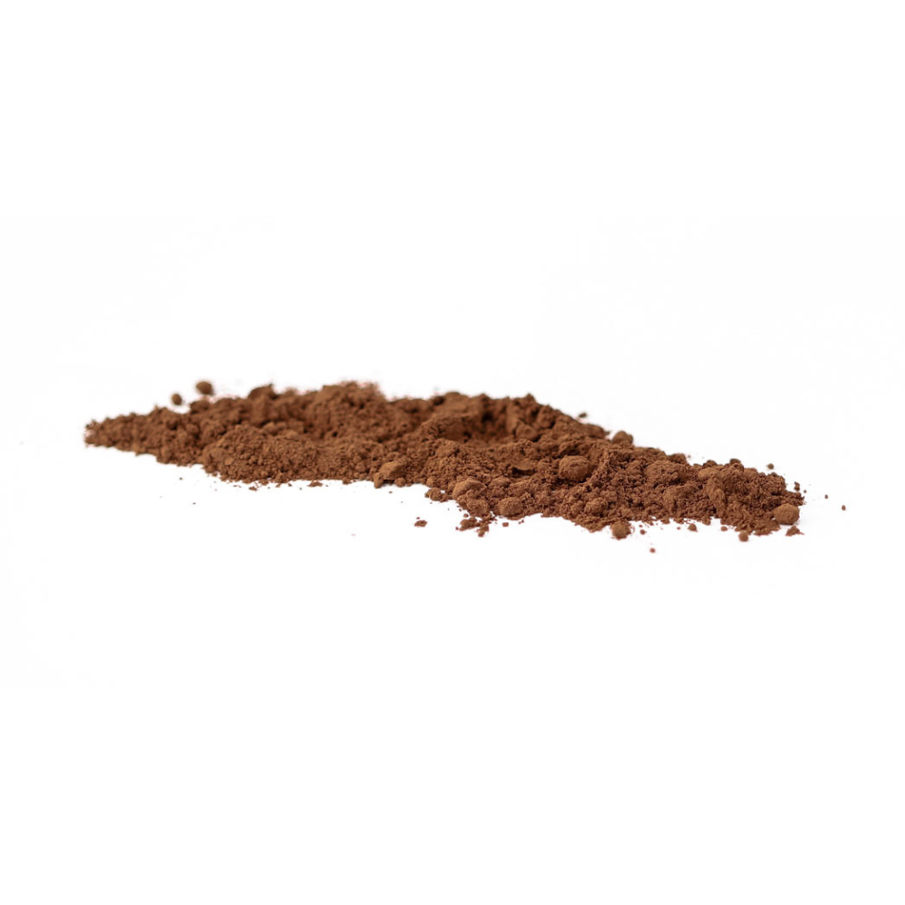 Cocoa powder sprinkled in a line on a white background.