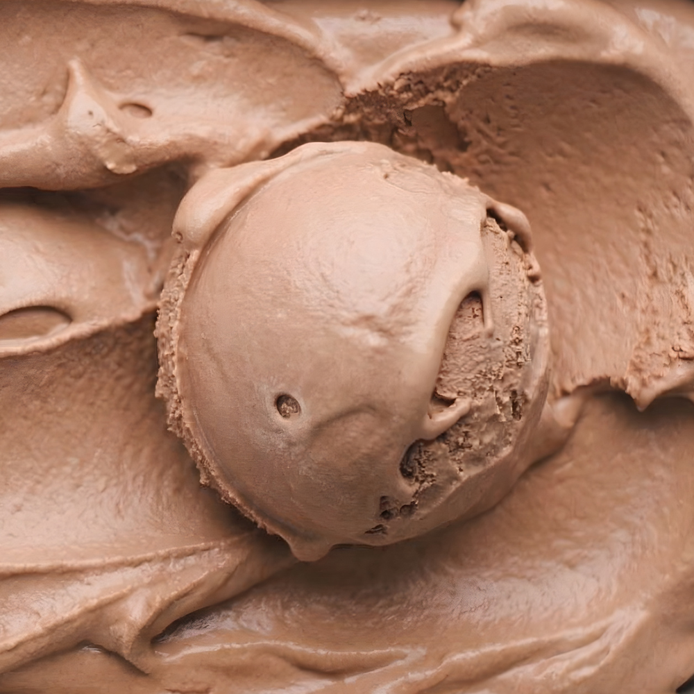 Close-up of a scoop of cocoa ice cream with a smooth, creamy texture.